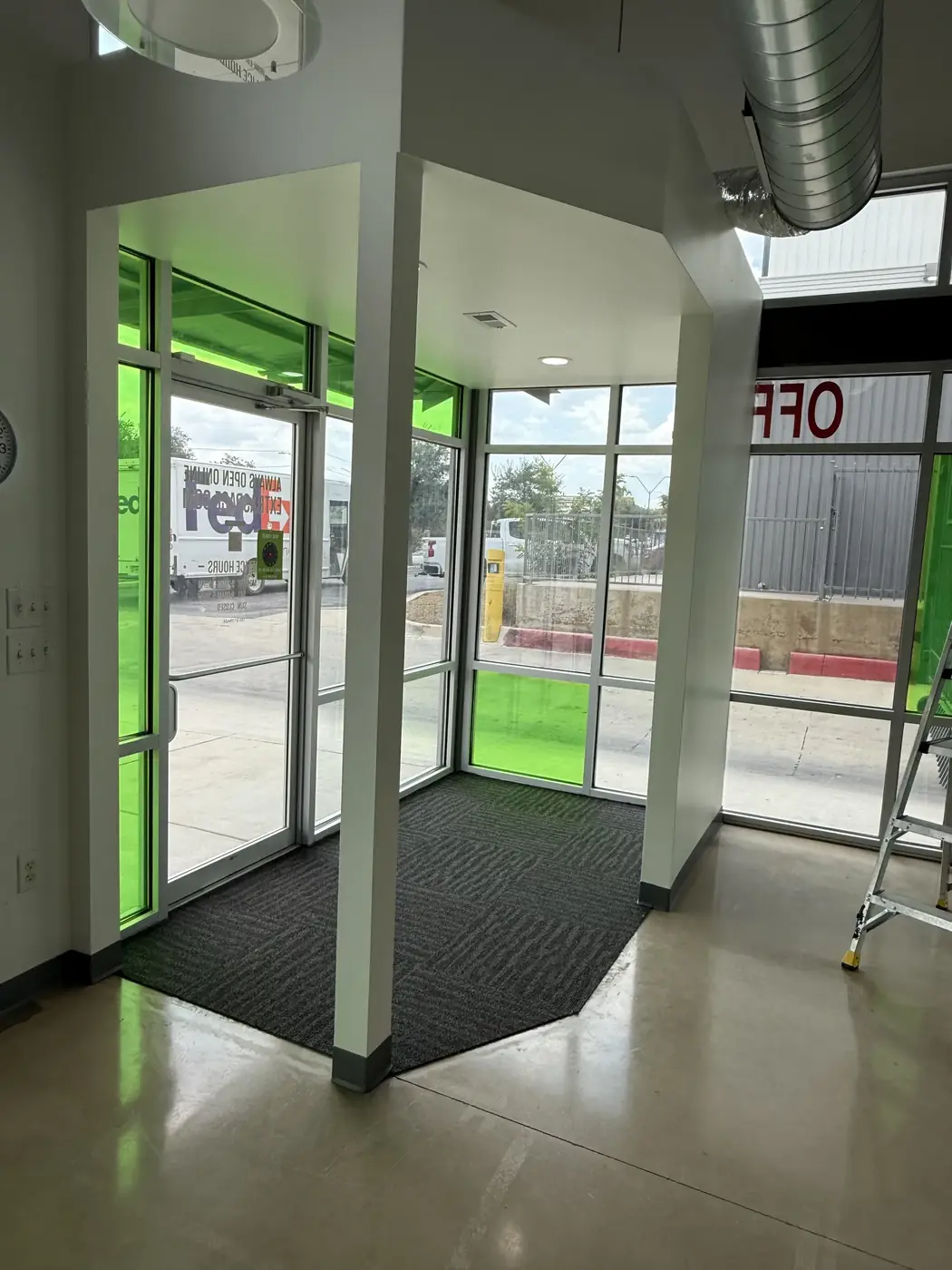 Green-tinted entry vestibule and interior glazing