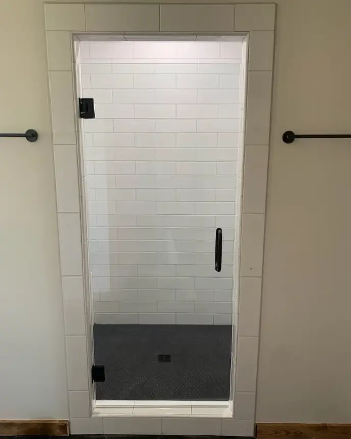 Black-framed shower door on a tiled base